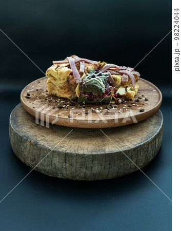 Brioche Truffle Ham Cheese Pumpkin Bread, mixed with Cheese Cake Christmas Protein Bar and mixed nuts sprinkle on the wooden tray. 98224044