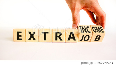 Extra job and income symbol. Concept words Extra job Extra income on wooden cubes. Businessman hand. Beautiful white table white background. Business extra job and income concept. Copy space. 98224573