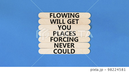Flowing symbol. Concept words Flowing will get you places forcing never could on wooden sticks. Beautiful blue table blue background copy space. Business motivational flowing concept. Flowing symbol. Concept words Flowing will get you places forcing never could on wooden sticks. Beautiful blue table blue background copy space. Business motivational flowing concept. 98224581