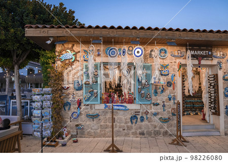 Side, Turkey. October 10, 2022. Various dreamcatchers with evil eyes and feathers hanging on roof and souvenirs arranged on wall for sale at shop in Turkish market 98226080