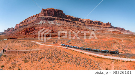 Page, Arizona. September 07, 2022. Aerial view of the cargo locomotive railroad engine crossing Arizona desert wilderness. Logistics transportation across America. 98226131