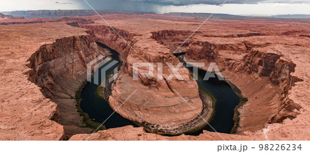 Panorama of Horseshoe Bend, Page Arizona. The Colorado River and a land mass made of orange sandstone. Made of twenty-three images, not one hundred percent accurate for perspective. Panorama of Horseshoe Bend, Page Arizona. The Colorado River and a land mass made of orange sandstone. Made of twenty-three images, not one hundred percent accurate for perspective. 98226234