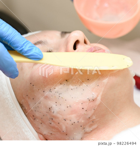 The process of applying a moisturizing mask to the face in a spa salon. The process of applying a moisturizing mask to the face in a spa salon. 98226494