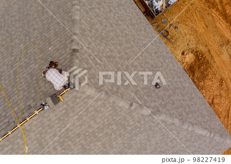 There was roofing worker on roof of house who installed new shingles 98227419