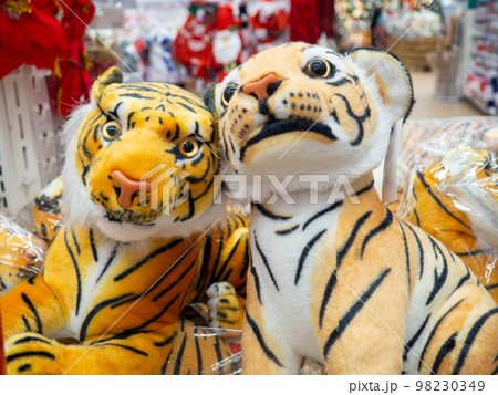 Christmas decorations in the store. Sale of gifts.  The symbol of the year on the counter. Plush tiger. 98230349