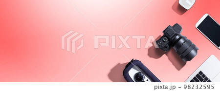 SLR camera with a laptop, a vr, a phone and a speaker 98232595