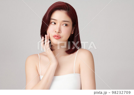 Beautiful young asian woman with clean fresh skin on grey background, Face care, Facial treatment, Cosmetology, beauty and spa, Asian women portrait. Beautiful young asian woman with clean fresh skin on grey background, Face care, Facial treatment, Cosmetology, beauty and spa, Asian women portrait. 98232709