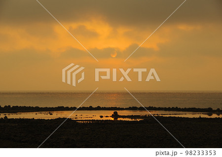 雲で見え隠れする朝日と有明海に差し込む光 98233353