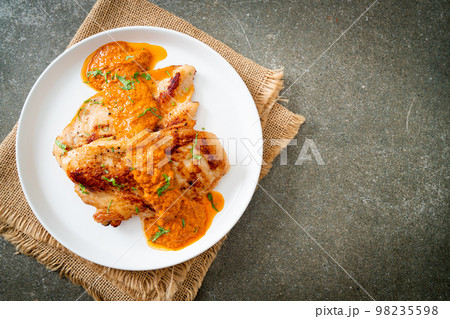 grilled chicken steak with red curry sauce 98235598