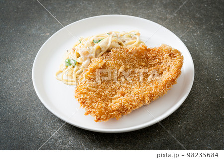 spaghetti pasta white cream sauce with fried fish 98235684