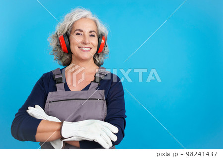 Mature female carpentry worker with tools and work uniform 98241437