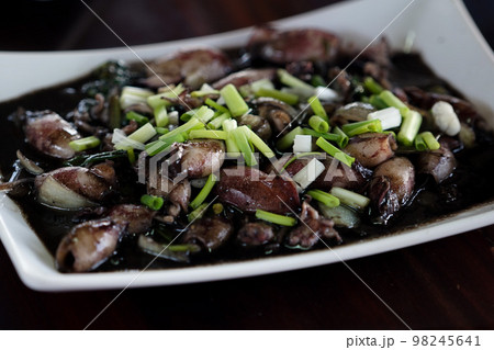 Aerial view dish of stir fried squid with ink ready for serve at the restaurant 98245641