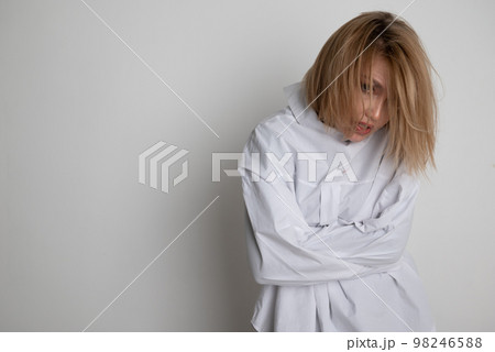 Woman with mental disorders in a straitjacket Woman with mental disorders in a straitjacket 98246588