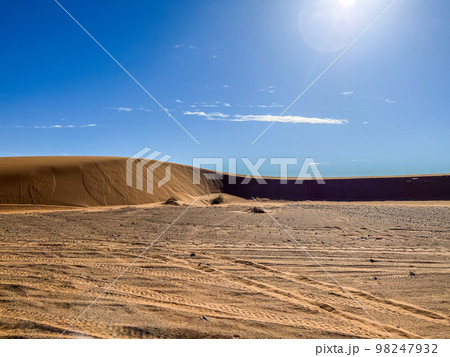 The sahara desert and its sand dunes with a blue sky as a background. 98247932