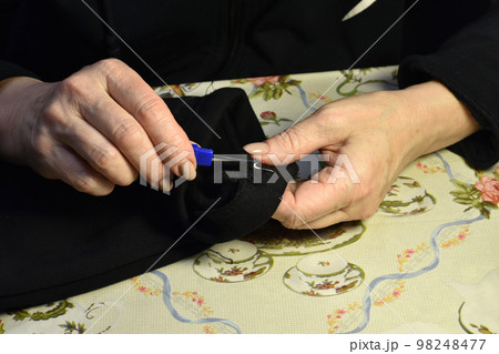 Hands of a seamstress working with fabric Hands of a seamstress working with fabric 98248477