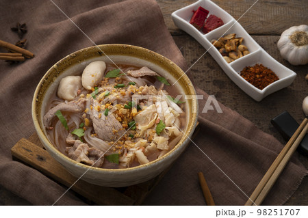 Noodles with pork and meatball in red soup (Look Chin Moo Nam Daeng).Thai street food 98251707