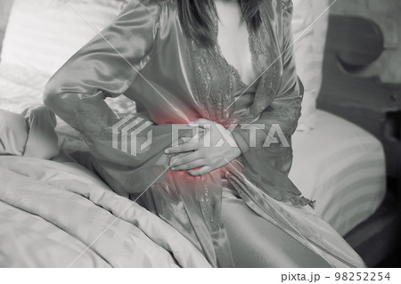Woman having waist pain at night. 98252254