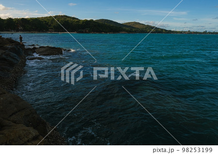 Rocky sea bach wave against blue sky Rocky sea bach wave against blue sky 98253199