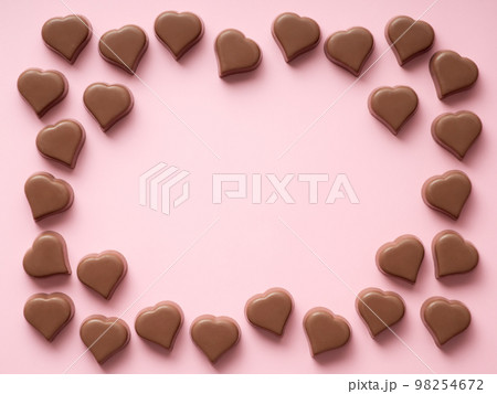Chocolate hearts confections frame on pink, copy space Chocolate hearts confections frame on pink, copy space 98254672