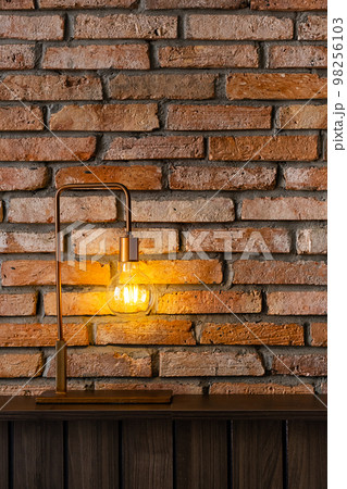 Bulb lamp against brick wall. Loft style design background. Bulb lamp against brick wall. Loft style design background. 98256103