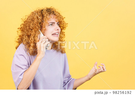 Angry woman talk to the mobile phone 98256192