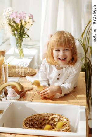 Girl in a white dress in the kitchen Girl in a white dress in the kitchen 98256658