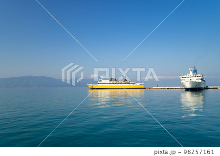 Harbour of Funchal on Madeira island Portugal with two big cruise ships on a blue sky day. Departure of one vessel and another on the pier. Popular all year destination for international tourists. 98257161