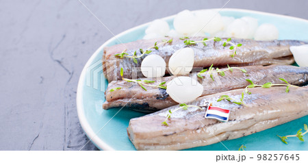 Freshly salted herring with salt, with copy space. Traditional Dutch delicacy. Freshly salted herring with salt, with copy space. Traditional Dutch delicacy. 98257645