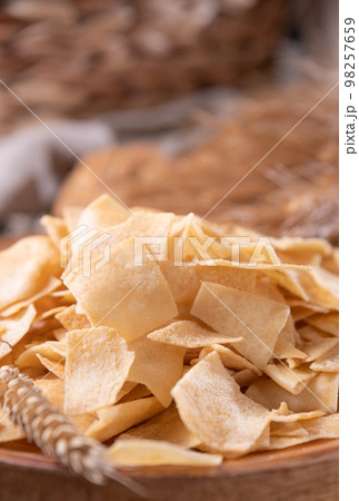 Bread chips, a typical appetizer for aperitivo, dinner in southern Italy and Sardinia. Thin baked Bread chips, a typical appetizer for aperitivo, dinner in southern Italy and Sardinia. Thin baked 98257659