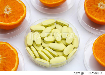 Vitamin C pills with  fresh orange citrus fruit isolated on white background. 98258094