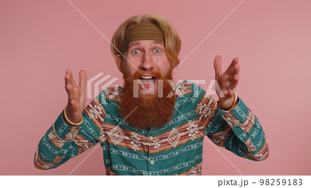 Amazed hippie man surprise looking at camera with big eyes, shocked by sudden victory, wow emotion 98259183