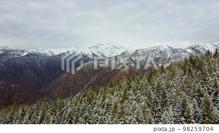 Winter landscape with snow covered mountain peaks. Winter landscape with snow covered mountain peaks. 98259704