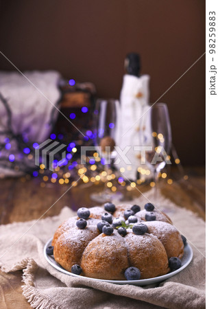 Christmas time in Italian tradition. Biscuit birthday cake with berries on the table 98259883