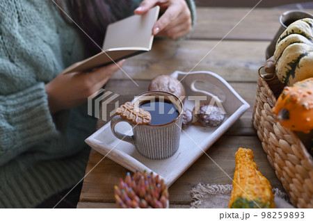Coffee and book in autumn. Coffee and book in autumn. 98259893