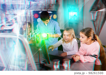 Interested tweens trying to get out of escape room, toned image 98261500