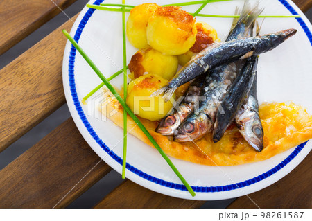 Deliciously fried sprats with scone and potato croquettes on plate Deliciously fried sprats with scone and potato croquettes on plate 98261587