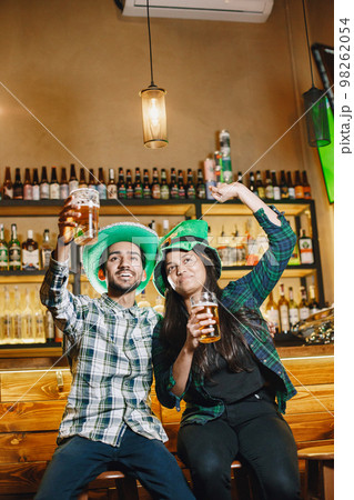 Indian friends celebrate St. Patrick's Day in a pub 98262054