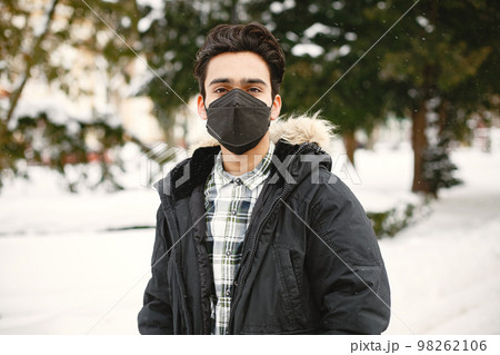 Indian in a black mask on street 98262106