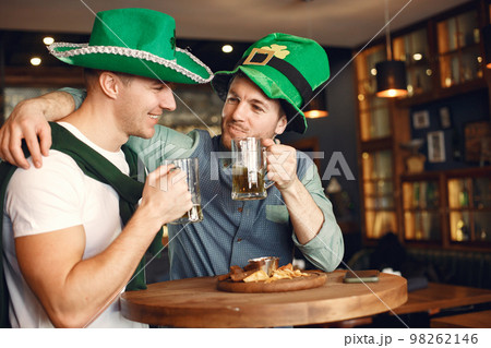 Men celebrate St. Patrick's Day at bar with a mug of beer 98262146