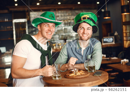 Men celebrate St. Patrick's Day at bar with a mug of beer Men celebrate St. Patrick's Day at bar with a mug of beer 98262151