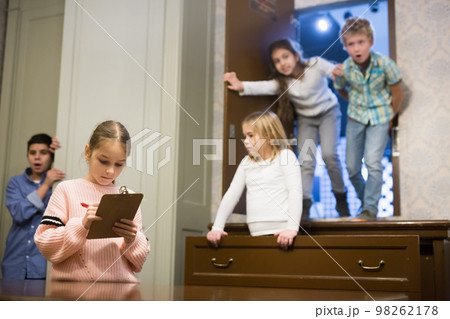 Tween girl solving conundrum to get out of escape room Tween girl solving conundrum to get out of escape room 98262178
