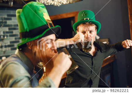 Men celebrate St. Patrick's Day at bar with a mug of beer 98262221