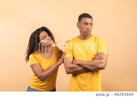 African american lady asking forgiveness after saying wrong words to beloved black boyfriend, yellow background 98265609