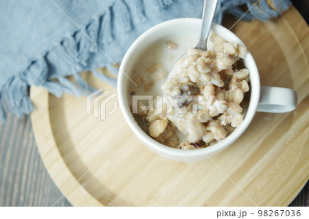top view of granola Musli and milk in a cup on table top view of granola Musli and milk in a cup on table 98267036