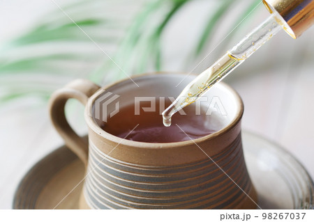 putting eucalyptus essential oils in cup of tea . putting eucalyptus essential oils in cup of tea . 98267037