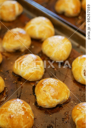 Freshly baked bread lies on the shelves ready for sale.  98267089