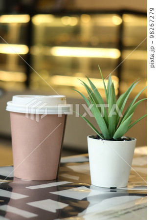 take away paper coffee cup o on cafe table 98267279