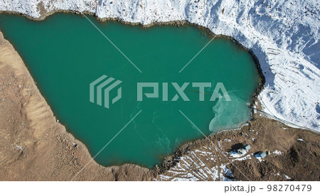 A mountain lake with emerald water is like mirror A mountain lake with emerald water is like mirror 98270479