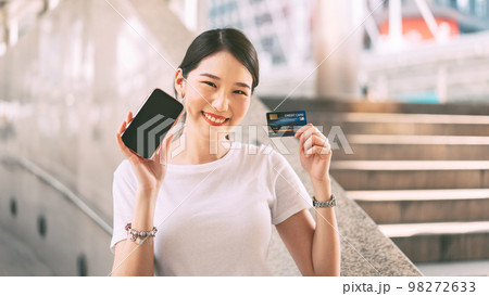Young adult business woman consumer holding smartphone blank screen space for mockup. Young adult business woman consumer holding smartphone blank screen space for mockup. 98272633
