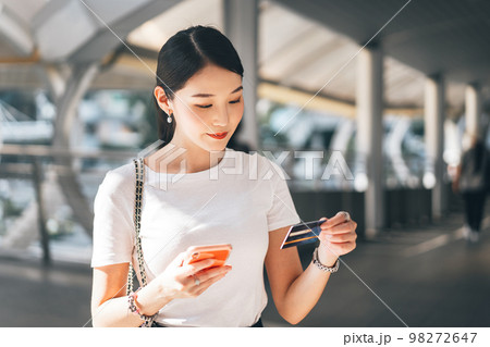 Young adult asian woman using creadit card and smartphone for online shopping and digital wallet Young adult asian woman using creadit card and smartphone for online shopping and digital wallet 98272647